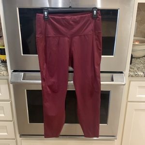 Stretchy polyester spandex yoga pants with side pockets. See photos for details